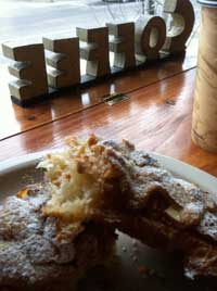 A deliciously flaky almond croissant at a table overlooking Front St